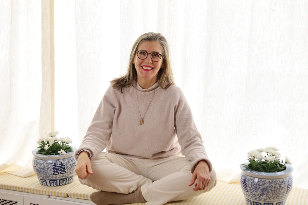 Eva sitting in front of the window smiling